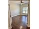 Bedroom features wood floors, neutral walls, and window with blind, offering a peaceful retreat at 806 Avenue G Ne, Winter Haven, FL 33881