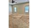 Bedroom featuring neutral carpet, two windows, ceiling fan, and neutral colored walls at 806 Avenue G Ne, Winter Haven, FL 33881