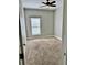 Bedroom featuring neutral carpet, ceiling fan, window, and neutral colored walls at 806 Avenue G Ne, Winter Haven, FL 33881