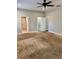 Large bedroom featuring neutral walls, ceiling fan, and access to the bathroom and closet at 806 Avenue G Ne, Winter Haven, FL 33881