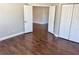 Bedroom featuring wood floors, neutral paint, bi-fold closet, and open door frame to additional space at 806 Avenue G Ne, Winter Haven, FL 33881