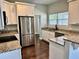 Modern kitchen with stainless steel appliances, granite countertops, and stylish white cabinetry at 806 Avenue G Ne, Winter Haven, FL 33881