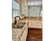 Well-lit kitchen features granite countertops, stainless steel sink, and modern black faucet at 806 Avenue G Ne, Winter Haven, FL 33881