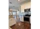 Kitchen with stainless steel oven and microwave and view of open living area and wood floors at 806 Avenue G Ne, Winter Haven, FL 33881