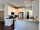 Well-lit kitchen with white cabinets, stainless steel appliances, and ample counter space at 806 Avenue G Ne, Winter Haven, FL 33881
