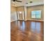 Bright living room showcasing wood floors, with a white front door and large windows at 806 Avenue G Ne, Winter Haven, FL 33881