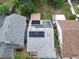 Aerial view of a home with solar panels, showcasing the neighborhood and the property's location at 9430 Daney St, Gotha, FL 34734