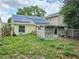 The backyard features solar panels, a door to the house, a storage area, and a grassy yard at 9430 Daney St, Gotha, FL 34734