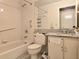 Bathroom featuring combination shower and tub with white fixtures and granite counters at 9430 Daney St, Gotha, FL 34734
