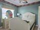 Bedroom with white furniture and accents, bright natural light, and neutral wall color at 9430 Daney St, Gotha, FL 34734