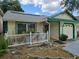 A well-maintained single story home with a small porch, updated roof, and solar panels at 9430 Daney St, Gotha, FL 34734