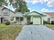 Charming single-story home featuring a cozy front porch and attached garage at 9430 Daney St, Gotha, FL 34734
