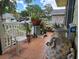 Cozy front porch with colorful pots, white chair, and charming decor at 9430 Daney St, Gotha, FL 34734