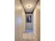 Hallway with tile flooring and framed artwork on the wall, leading to various rooms at 9430 Daney St, Gotha, FL 34734