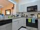 Well-equipped kitchen with granite countertops, stainless steel appliances, and ample cabinet space at 9430 Daney St, Gotha, FL 34734