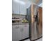 Kitchen featuring stainless steel refrigerator, granite counters, and light gray cabinetry at 9430 Daney St, Gotha, FL 34734
