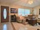 Inviting living room with decorative tile flooring, a comfortable chair, and natural lighting at 9430 Daney St, Gotha, FL 34734