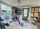 Well-lit storage area with tiled floors and shelving and easy access to the outdoors at 9430 Daney St, Gotha, FL 34734