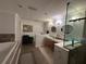 Primary bathroom with double sinks, soaking tub and a glass enclosed shower at 104 Woden Way, Winter Haven, FL 33884