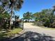 The property is accessed via an elegant entry gate leading to a paved driveway, ensuring privacy and security for residents at 104 Woden Way, Winter Haven, FL 33884