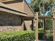 The facade showcases a harmonious blend of brickwork and stylish architectural elements, accentuated by well-manicured landscaping at 104 Woden Way, Winter Haven, FL 33884