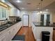 Beautiful kitchen with white cabinets, black countertops, an island, and stainless steel appliances at 104 Woden Way, Winter Haven, FL 33884
