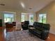 Spacious living room with hardwood floors, a vaulted ceiling, and abundant natural light at 104 Woden Way, Winter Haven, FL 33884