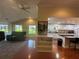 Open concept living room and kitchen features bright windows and wood flooring at 104 Woden Way, Winter Haven, FL 33884