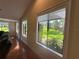 Living room featuring hardwood floors, crown molding, and large windows overlooking the yard at 104 Woden Way, Winter Haven, FL 33884