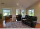 Bright living room featuring hardwood floors, a vaulted ceiling, and abundant natural light at 104 Woden Way, Winter Haven, FL 33884