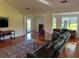 Open living room featuring hardwood floors, comfortable seating, and a view of the patio at 104 Woden Way, Winter Haven, FL 33884