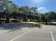 Street view of residential homes with mature trees and lush green lawns at 104 Woden Way, Winter Haven, FL 33884