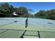 Community tennis court with gate and information on use at 104 Woden Way, Winter Haven, FL 33884