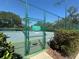Entrance to tennis court with rules sign posted at 104 Woden Way, Winter Haven, FL 33884