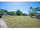 Expansive backyard featuring lush green grass, mature trees, and a storage shed, perfect for outdoor activities at 109 Pasco Se Rd, Winter Haven, FL 33884