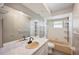 Bathroom with a large mirror above the vanity, a combination tub and shower, and tile surround at 109 Pasco Se Rd, Winter Haven, FL 33884