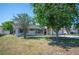 Quaint single-story home with mature landscaping and a well-maintained lawn at 109 Pasco Se Rd, Winter Haven, FL 33884
