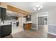 Open concept kitchen and dining area with modern flooring, barn door, and stylish lighting at 109 Pasco Se Rd, Winter Haven, FL 33884