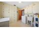 Well-equipped laundry room with storage cabinets, utility sink, washer, and dryer hookups at 109 Pasco Se Rd, Winter Haven, FL 33884