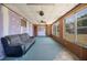 Spacious sunroom with large windows, a ceiling fan, and access to the backyard at 109 Pasco Se Rd, Winter Haven, FL 33884
