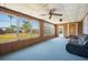 Bright sunroom with multiple large windows offering serene views of the surrounding backyard and greenery at 109 Pasco Se Rd, Winter Haven, FL 33884