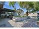 Spacious backyard featuring a patio, dock, lush tree, and plenty of room for outdoor relaxation and entertainment at 117 Bream St, Haines City, FL 33844