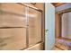 Bathroom featuring shower with glass doors and tile flooring, offering a clean and functional space at 117 Bream St, Haines City, FL 33844