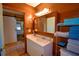 Bathroom vanity with wood paneling and shelving for towels, combining rustic charm with modern convenience at 117 Bream St, Haines City, FL 33844