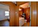 Hallway view of a bathroom with wood paneling, a single sink vanity, a toilet, and a towel rack at 117 Bream St, Haines City, FL 33844
