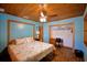 Bedroom with built-in wood closet, desk, ceiling fan, and wood ceiling, offering a cozy retreat at 117 Bream St, Haines City, FL 33844