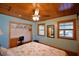 Bedroom featuring wood ceiling, desk, ceiling fan, and built-in closet, creating a functional space at 117 Bream St, Haines City, FL 33844