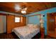Bedroom with built-in wood closet, ceiling fan, and wood ceiling, creating a warm and inviting atmosphere at 117 Bream St, Haines City, FL 33844