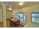 Bright dining area with a view of the outdoors, complemented by a wooden dining table and chairs at 117 Bream St, Haines City, FL 33844