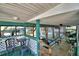 Large covered dock featuring a dining area, ceiling fans, and scenic waterfront views at 117 Bream St, Haines City, FL 33844